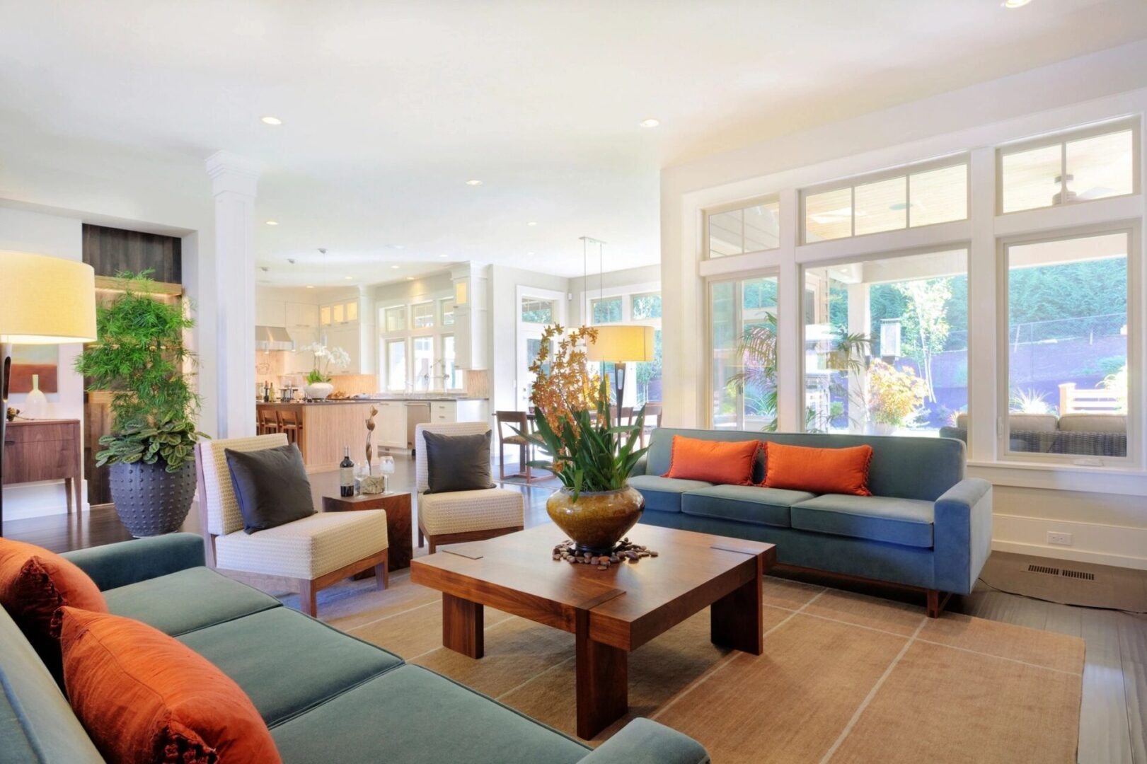 A living room with couches, tables and chairs.